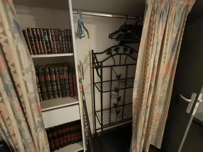 a room with a book shelf filled with books at maison chalet in Bessède-de-Sault