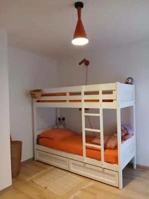 a bedroom with a bunk bed with an orange mattress at La route des vignes in Val-de-Dagne