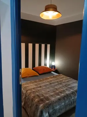 a bedroom with a bed with a black headboard at La route des vignes in Val-de-Dagne