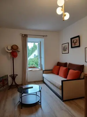 a living room with a couch and a table at La route des vignes in Val-de-Dagne