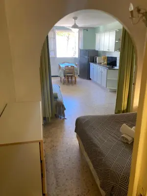 a bedroom with a dog standing in the middle of a room at T1 - Centre ville rez-de-chaussée in Port-la-Nouvelle