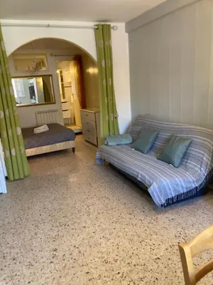 a bedroom with two beds and a mirror at T1 - Centre ville rez-de-chaussée in Port-la-Nouvelle