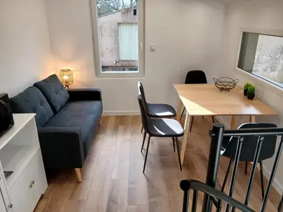 a living room with a couch and a table at Cottage with large garden in Rieumajou