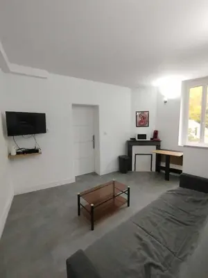 a living room with a couch and a coffee table at T2 Au pied de la passerelle in Mazamet