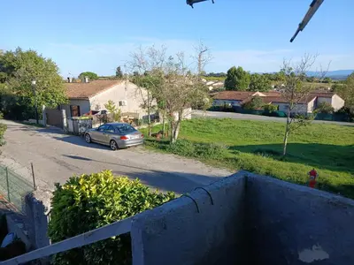 a car parked on a street in a residential neighborhood at Appartement 2 pièces petit village au calme in Moussoulens