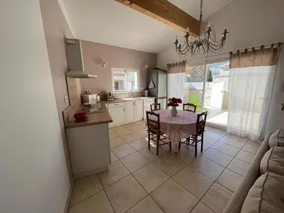a kitchen and dining room with a table and chairs at Le gîte d 'Anaïs in La Redorte