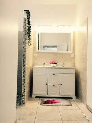 a bathroom with a sink and a mirror at Le gîte d 'Anaïs in La Redorte