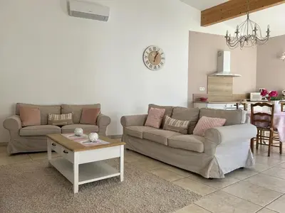 a living room with two couches and a table at Le gîte d 'Anaïs in La Redorte