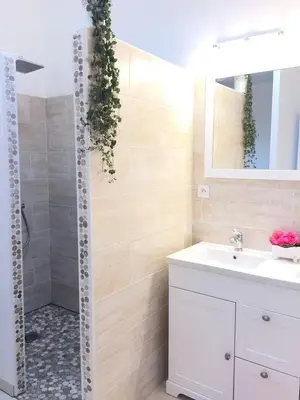 a bathroom with a white sink and a shower at Le gîte d 'Anaïs in La Redorte