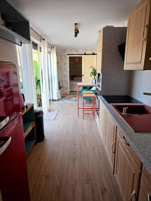 a kitchen with wooden floors and a counter top at Studio Conteneur in Cruscades