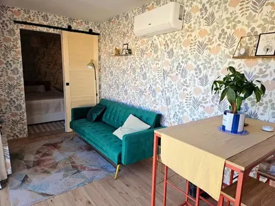 a living room with a green couch and a table at Studio Conteneur in Cruscades