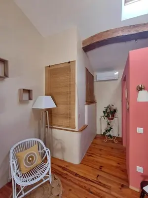 a room with a white chair and a window at SAINT-JULIA - Studio in Saint-Julia