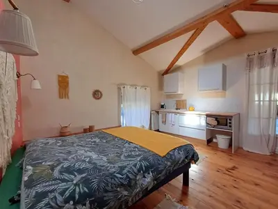 a bedroom with a bed and a kitchen in it at SAINT-JULIA - Studio in Saint-Julia