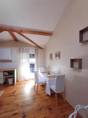 a dining room with a white table and chairs at SAINT-JULIA - Studio in Saint-Julia