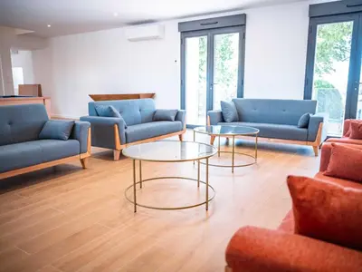 a living room with couches and tables and windows at La Borie Lautrecoise - 26 pers - Piscine chauffée & Clim in Jonquières