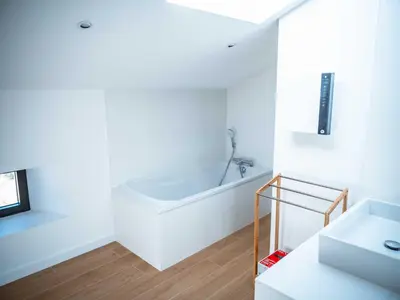 a white bathroom with a tub and a sink at La Borie Lautrecoise - 26 pers - Piscine chauffée & Clim in Jonquières