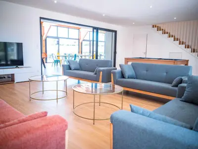 a living room with couches and tables and a television at La Borie Lautrecoise - 26 pers - Piscine chauffée & Clim in Jonquières
