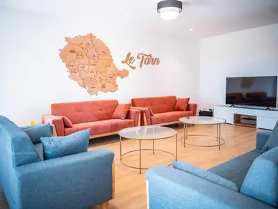 a living room with couches and tables and a tv at La Borie Lautrecoise - 26 pers - Piscine chauffée & Clim in Jonquières