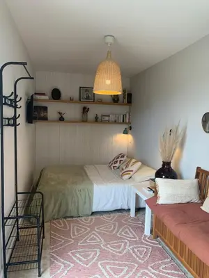 a bedroom with two beds and a couch at Studio Cosy en Conteneur-Maritime in Tabre