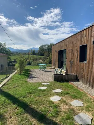 a wooden building with a bench in front of it at Studio Cosy en Conteneur-Maritime in Tabre