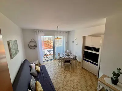 a living room with a blue couch and a table at Appartement 2 pièces - 5 couchages Port la Nouvelle PN440-023 in Port-la-Nouvelle