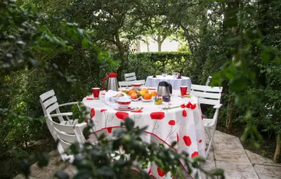 a table with a white table cloth with fruit on it at L'Oustal d'en Paris in Nogaret