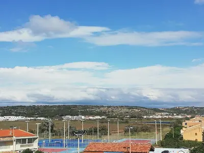 a view of a tennis court in a city at Bord de mer avec piscine intérieure chauffée in Port-la-Nouvelle