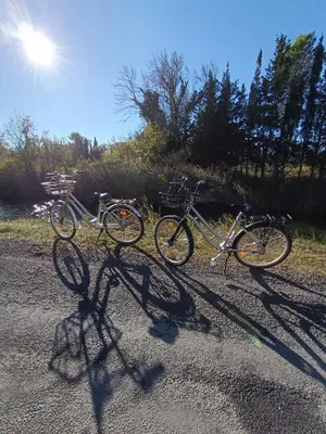 two bikes parked on the side of a road at Bouddha Fleurs de Lotus in Sigean