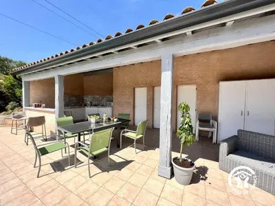 a patio with a table and chairs and a couch at Le gite aux oliviers in La Redorte