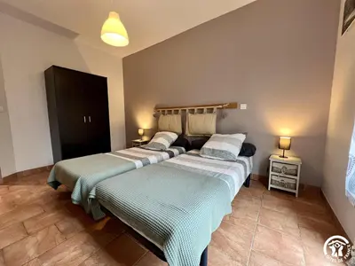two beds sitting next to each other in a room at Le gite du pech de saint jean in La Redorte