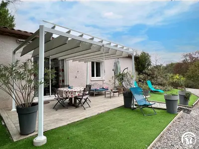 a patio with a table and chairs under a pergola at Le gite du pech de saint jean in La Redorte