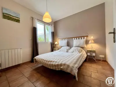 a bedroom with a bed and a window at Le gite du pech de saint jean in La Redorte