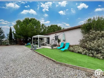 a backyard with a lawn with chairs and a gazebo at Le gite du pech de saint jean in La Redorte