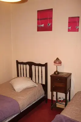 a bedroom with a bed and a table with a lamp at Chambre 2 in Saint-Michel-de-Lanès