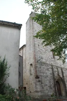 a tall brick building with a tower on the side of it at Chambre 2 in Saint-Michel-de-Lanès