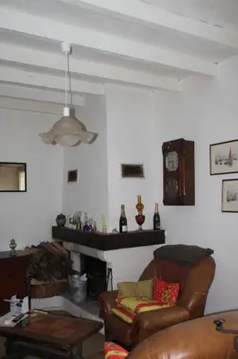 a living room with a couch and a fireplace at Chambre 2 in Saint-Michel-de-Lanès