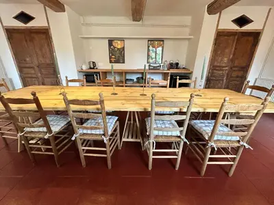 a large wooden table and chairs in a room at Château de Gragnos in Saint-Chinian