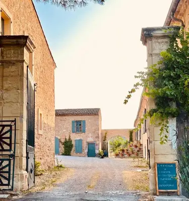 an empty street in an italian village with buildings at Château de Gragnos in Saint-Chinian