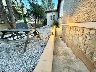 a picnic table sitting next to a brick building at Logement en souplexe indépendant dans une propriété in Castres