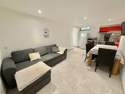 a living room with a couch and a table at Logement en souplexe indépendant dans une propriété in Castres