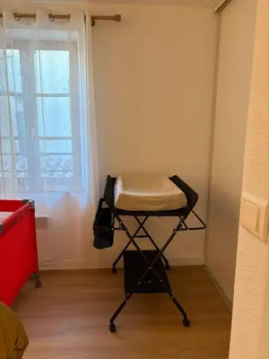 a stool in a room with a window at L'étoile des remparts in Lagrasse