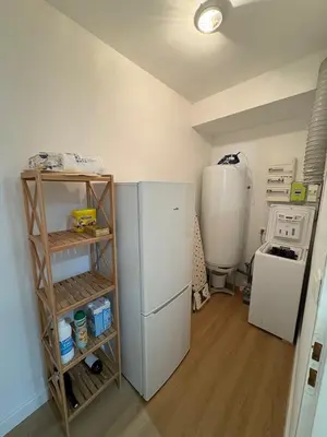 a kitchen with a refrigerator and a washer and dryer at L'étoile des remparts in Lagrasse