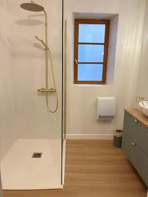 a shower with a glass door in a bathroom at L'étoile des remparts in Lagrasse