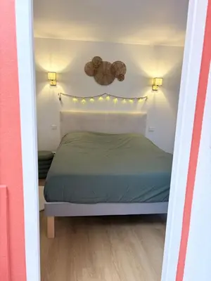 a bedroom with a bed and lights on the wall at L'étoile des remparts in Lagrasse