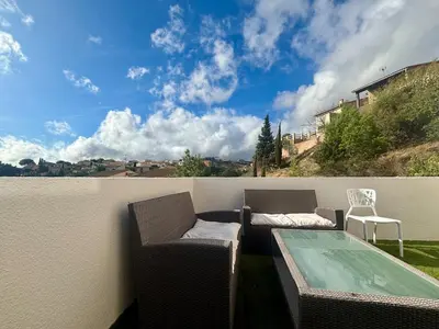 a kitchen with white cabinets and a counter top at T3 lumineux - Terrasse- Proche des grands buffets in Narbonne