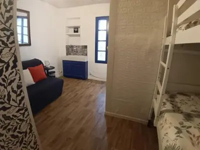 a room with a bunk bed and a living room at Chambre privée chez l'habitant, Les Maisons de Gaia in Tuchan