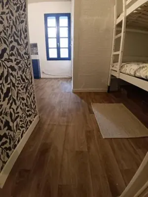 a room with bunk beds and a wooden floor at Chambre privée chez l'habitant, Les Maisons de Gaia in Tuchan