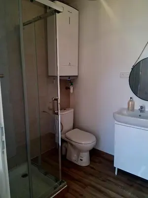 a bathroom with a toilet and a glass shower at Le Repaire Secret, studio cosy et calme Narbonne in Narbonne
