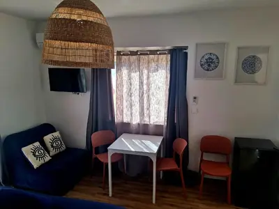 a room with a table and chairs and a window at Le Repaire Secret, studio cosy et calme Narbonne in Narbonne