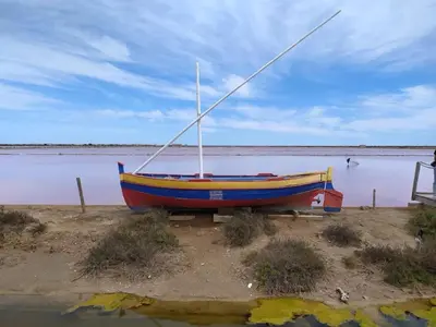 a boat sitting on the shore of a body of water at Villa with private pool and panoramic view in Félines-Minervois